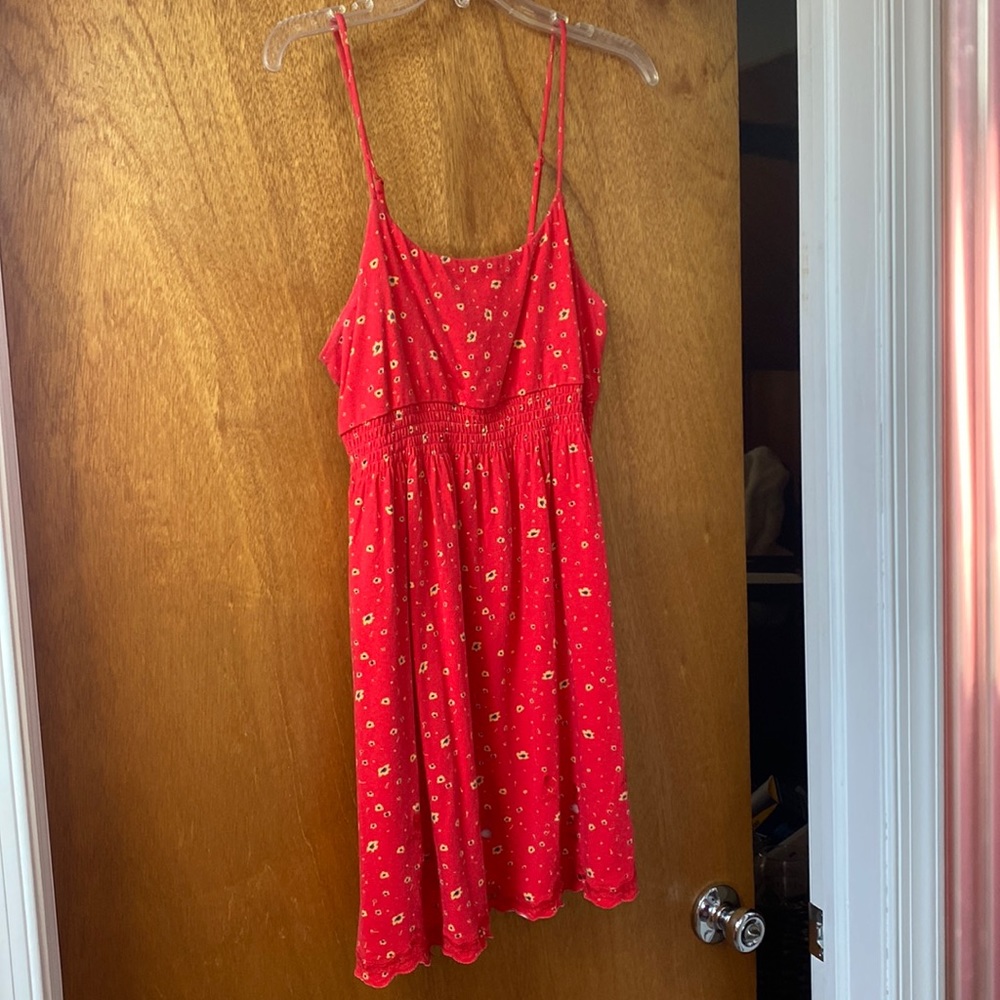 Red spaghetti strap mini dress with yellow flowers.